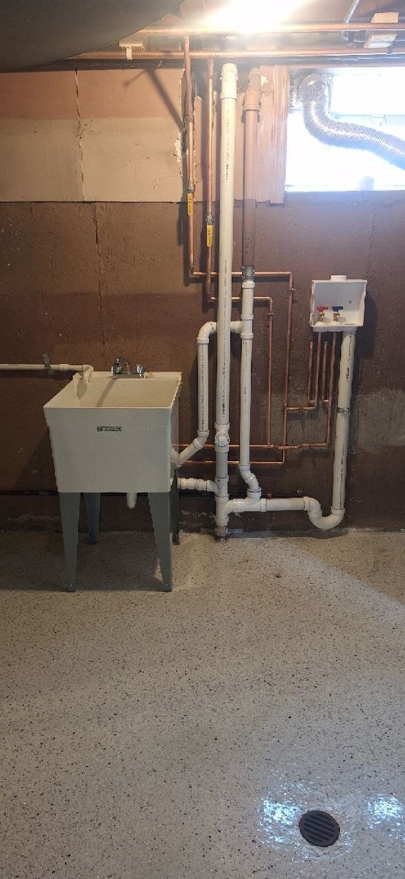 Basement utility sink with PVC drain and vent piping