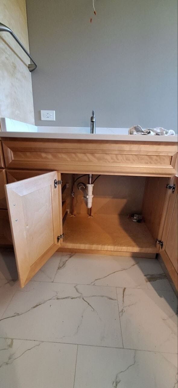 Bathroom vanity with new faucet and drain plumbing