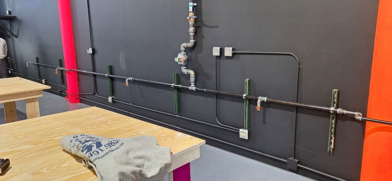Water and gas lines neatly run along a commercial wall